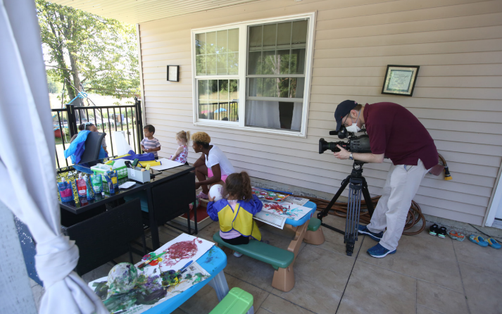 Senior Education Specialist Ed Kirchgnesser captures footage for a child care video production.