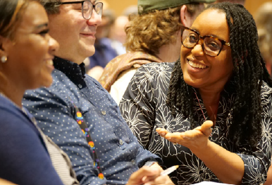 Education Specialist Audene Henry chatting with other PDP Staff
                at the PDP Staff Recognition Event.