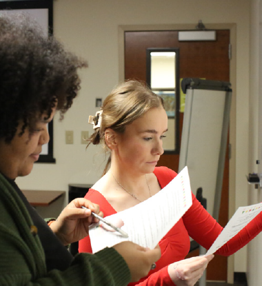 Administrative Assistant II Jaelyn Jackson and Project Staff Assistant Ciara Haag preparing for a training class.